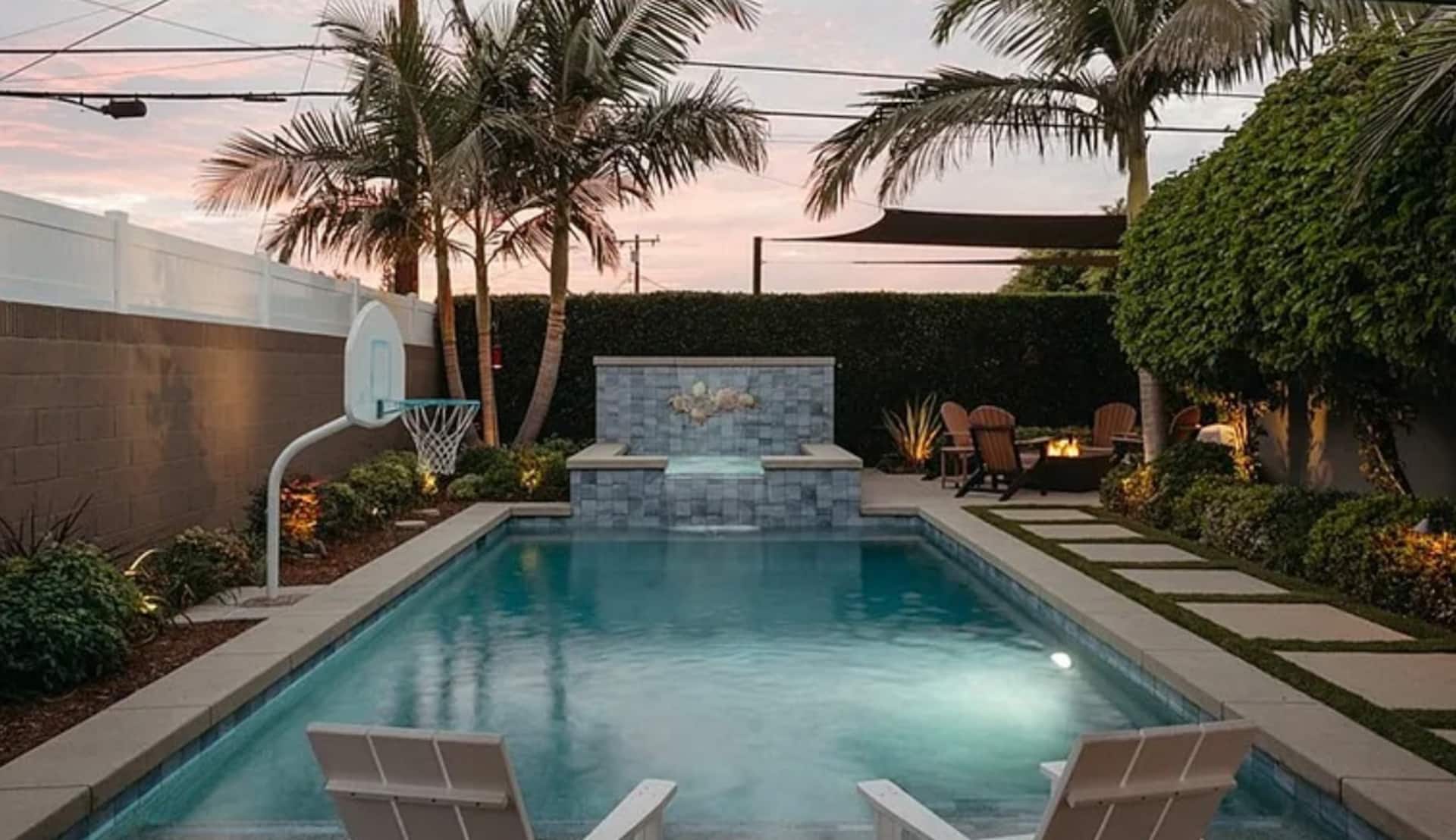 Saltwater pool and spa surrounded by lounge seating